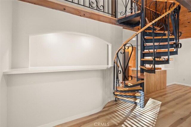 stairway featuring wood-type flooring