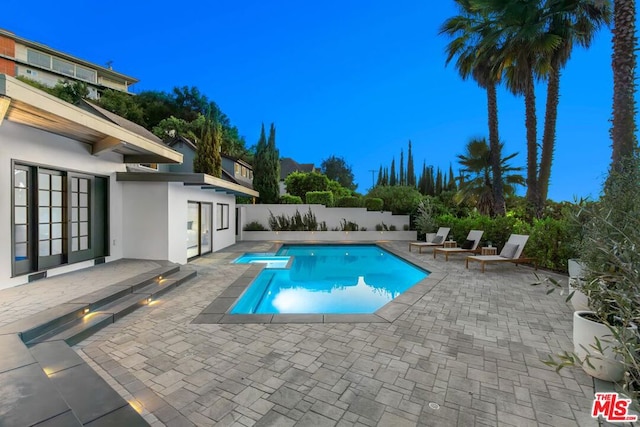 view of swimming pool with a patio area and a jacuzzi