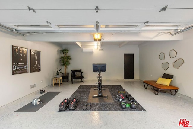 exercise room featuring an AC wall unit