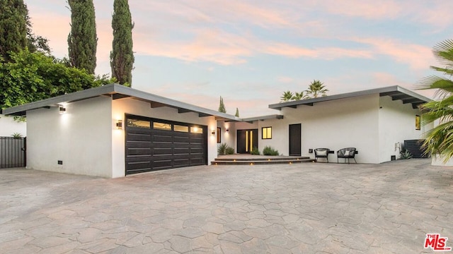 contemporary home with central AC and a garage