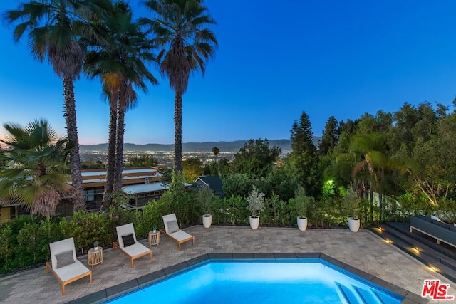 view of pool at dusk