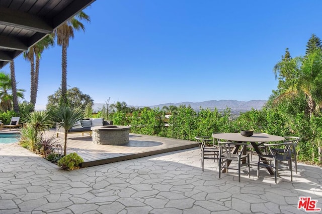 view of patio featuring a mountain view and a fire pit