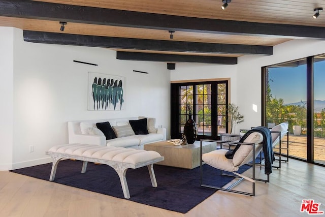 living room with hardwood / wood-style floors, vaulted ceiling with beams, and wood ceiling