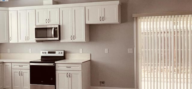 kitchen featuring white cabinets and appliances with stainless steel finishes