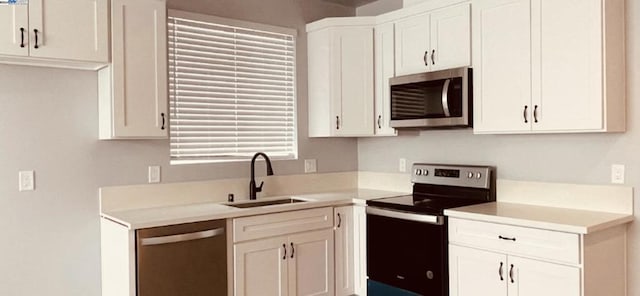 kitchen featuring white cabinets, sink, and stainless steel appliances