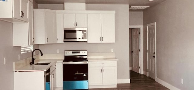 kitchen with white cabinetry, dark wood-type flooring, and appliances with stainless steel finishes