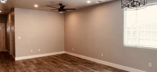 unfurnished room with dark hardwood / wood-style flooring, a wealth of natural light, and ceiling fan