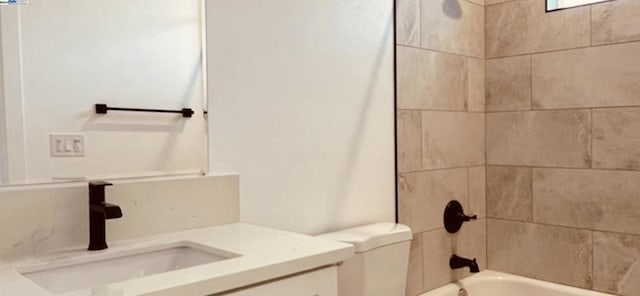 full bathroom with vanity, toilet, and tiled shower / bath combo