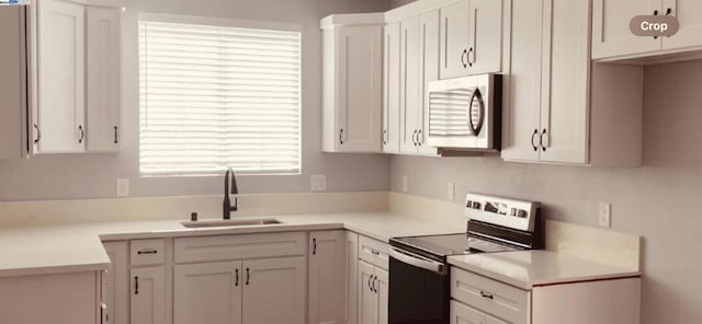 kitchen featuring sink, white cabinetry, and stainless steel appliances