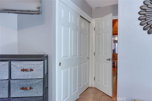 corridor with light hardwood / wood-style floors