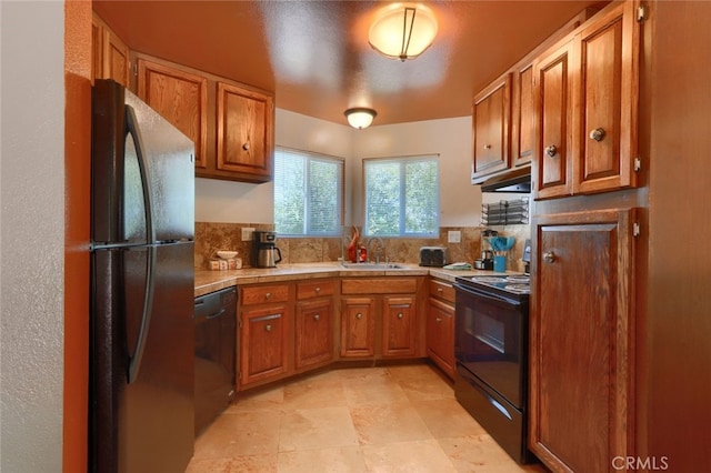 kitchen with sink, backsplash, and black appliances