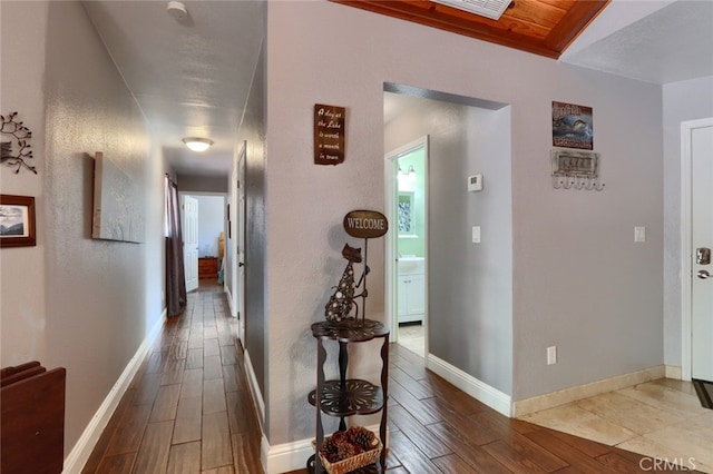 hallway with hardwood / wood-style flooring