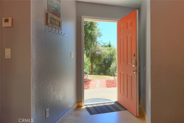 entryway with light tile patterned floors