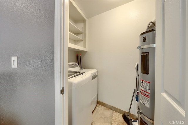 clothes washing area with washer and clothes dryer and water heater