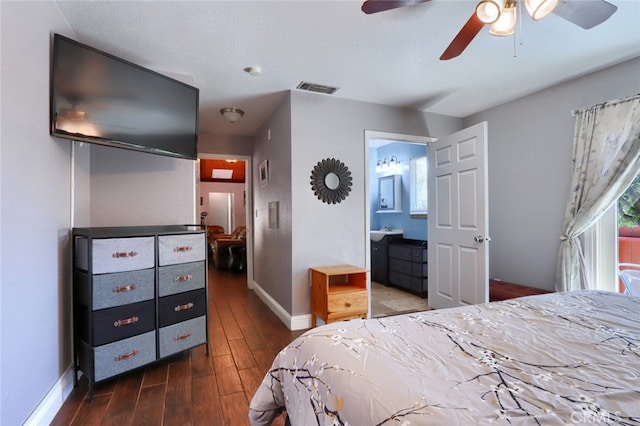 bedroom featuring ensuite bathroom, ceiling fan, and dark wood-type flooring