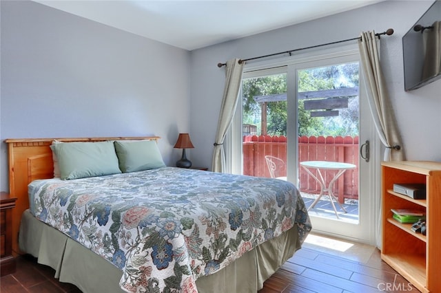 bedroom featuring access to exterior and hardwood / wood-style floors