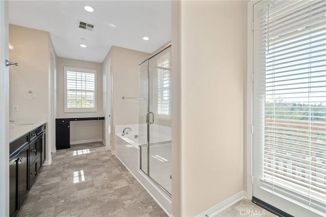 bathroom featuring vanity and plus walk in shower