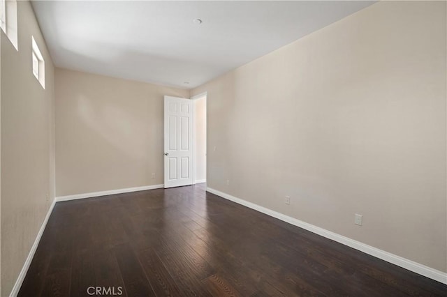 empty room featuring dark wood-type flooring