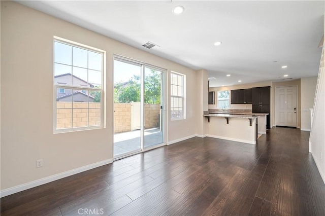 unfurnished living room with dark hardwood / wood-style flooring