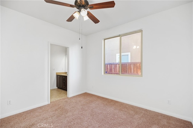 carpeted spare room with ceiling fan