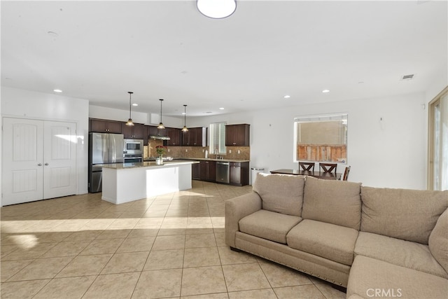 tiled living room featuring sink