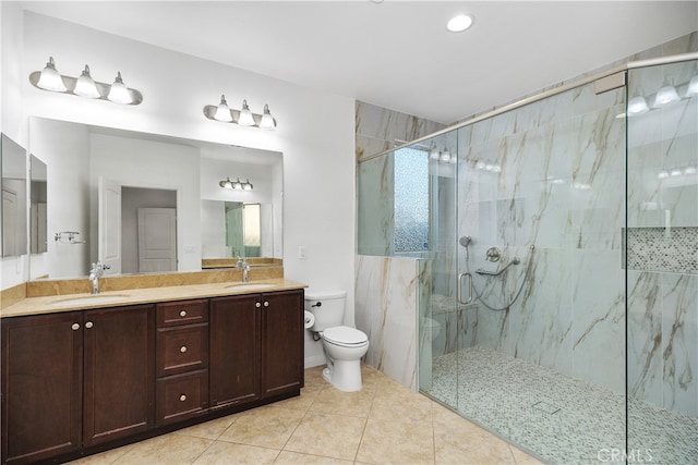 bathroom featuring tile patterned floors, vanity, toilet, and a shower with door