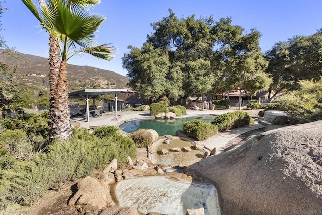 view of yard featuring a mountain view and a patio