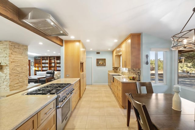 kitchen with wall chimney exhaust hood, hanging light fixtures, light tile patterned floors, an inviting chandelier, and stainless steel stove