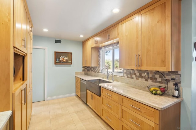 kitchen with dishwasher, backsplash, light stone countertops, and sink