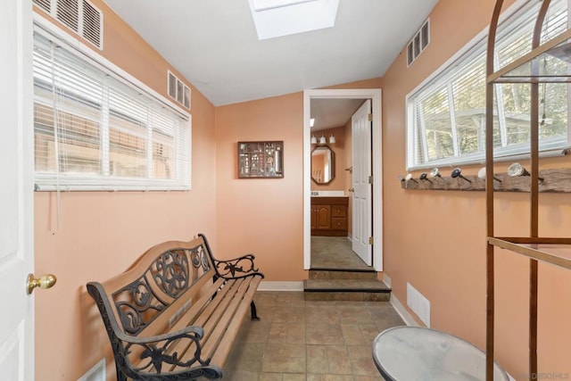 bathroom featuring vaulted ceiling with skylight