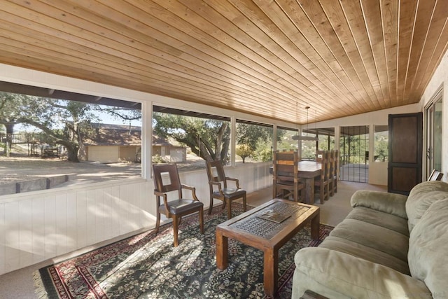 sunroom / solarium with lofted ceiling, wood ceiling, and a wealth of natural light