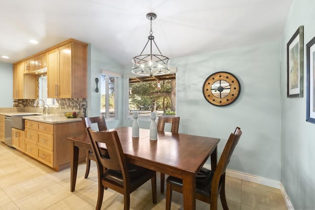 dining room with a notable chandelier, light tile patterned floors, and sink