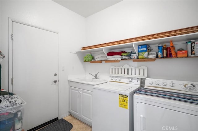 laundry area featuring cabinets, washing machine and dryer, light tile patterned flooring, and sink