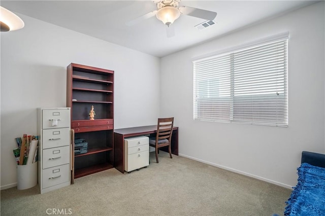 carpeted office with ceiling fan