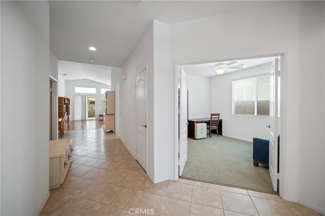 hall featuring light carpet and lofted ceiling