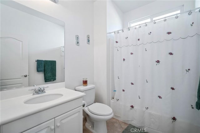 full bathroom featuring tile patterned floors, shower / tub combo with curtain, vanity, and toilet