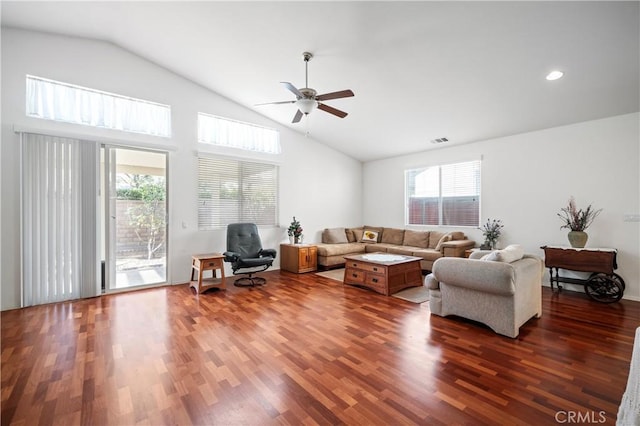 living room featuring dark hardwood / wood-style floors, ceiling fan, and a healthy amount of sunlight