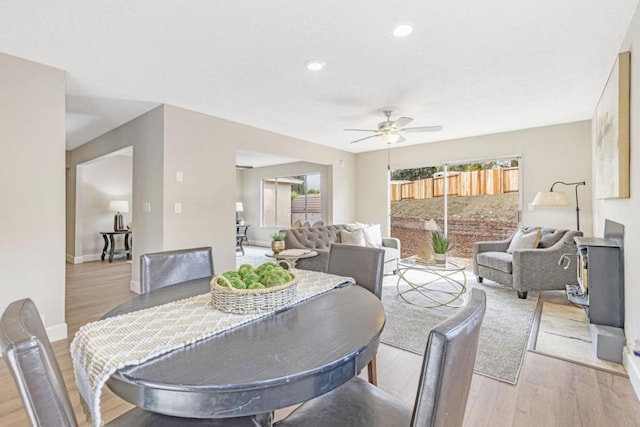 dining area with ceiling fan and light hardwood / wood-style flooring