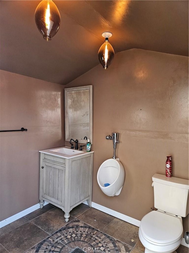 bathroom featuring toilet, vanity, and vaulted ceiling