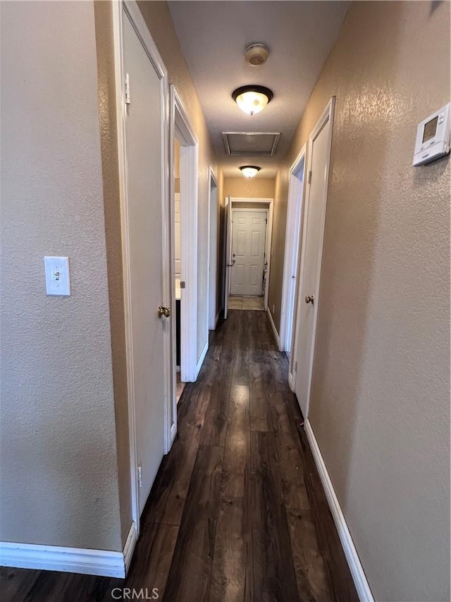 corridor featuring dark hardwood / wood-style flooring