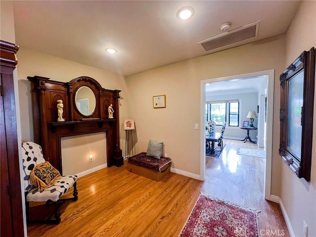 sitting room with light hardwood / wood-style flooring