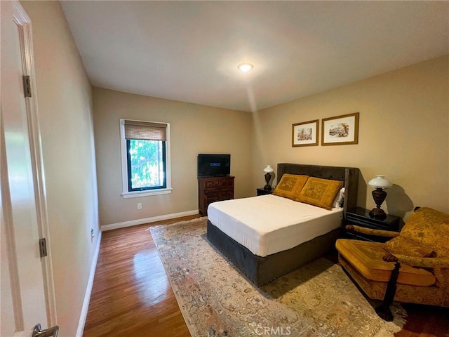 bedroom with wood-type flooring