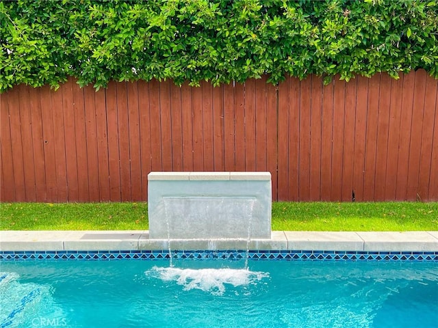 view of swimming pool featuring pool water feature