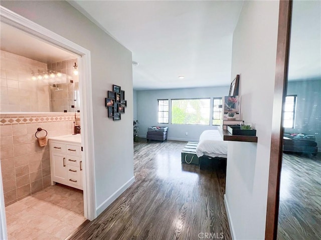 corridor featuring tile walls and hardwood / wood-style flooring