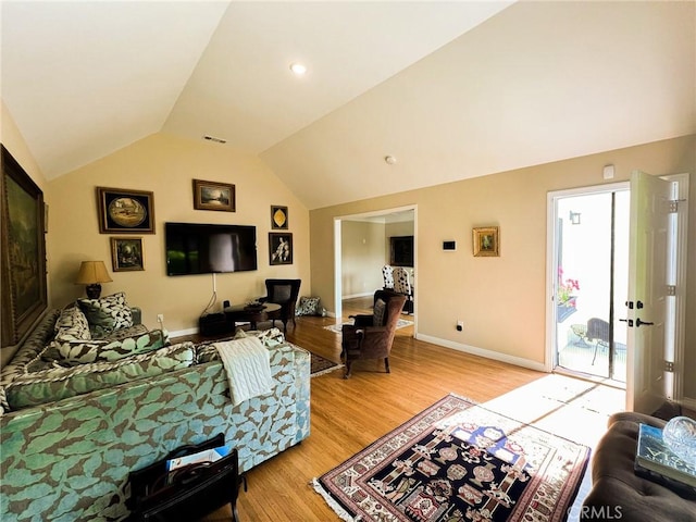 living room with light hardwood / wood-style flooring and lofted ceiling