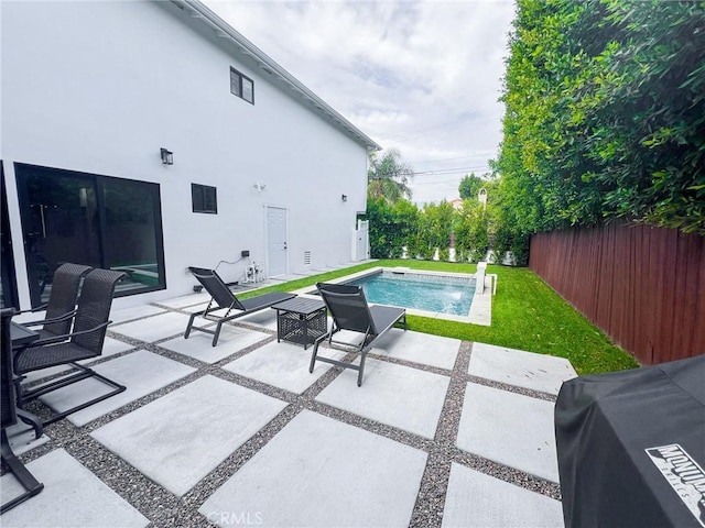 view of pool featuring pool water feature, a patio, and area for grilling