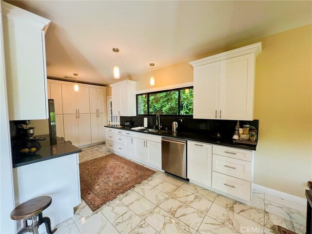 kitchen featuring stainless steel dishwasher, decorative backsplash, white cabinets, and hanging light fixtures