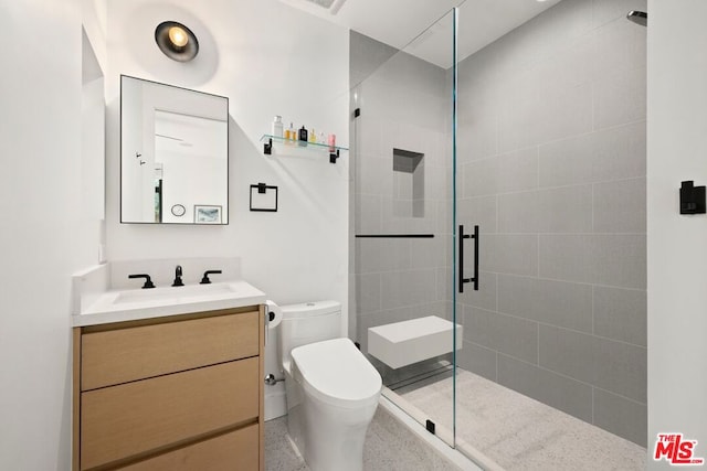 bathroom with an enclosed shower, vanity, and toilet