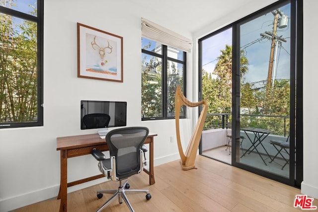 office with light wood-type flooring