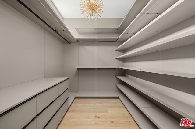 interior space featuring light wood-type flooring and an inviting chandelier